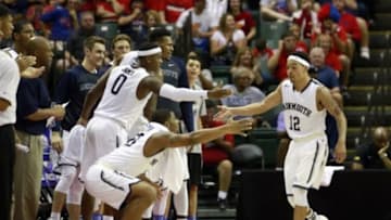 Nov 26, 2015; Lake Buena Vista, FL, USA; Monmouth Hawks guard Justin Robinson (12) is congratulated by the bench after being fouled against the Notre Dame Fighting Irish during the second half at ESPN Wide World of Sports Complex. Monmouth beat Notre Dame 70-68. Mandatory Credit: Kim Klement-USA TODAY Sports
