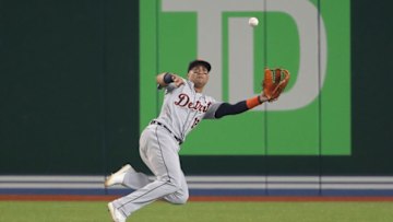 TORONTO, ON - JULY 1: Leonys Martin #12 of the Detroit Tigers is unable to hold on to a line drive to center field and cannot make the catch in the fourth inning during MLB game action as Kevin Pillar #11 of the Toronto Blue Jays hits a single at Rogers Centre on July 1, 2018 in Toronto, Canada. (Photo by Tom Szczerbowski/Getty Images)