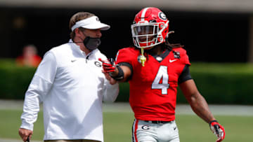 ATHENS, GA - APRIL 17: Head coach Kirby Smart speaks with running back James Cook #4 of the Georgia Bulldogs during the first half of the G-Day spring game at Sanford Stadium on April 17, 2021 in Athens, Georgia. (Photo by Todd Kirkland/Getty Images)
