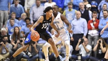 Feb 17, 2016; Chapel Hill, NC, USA; Duke Blue Devils guard Brandon Ingram (14) dribbles as North Carolina Tar Heels forward Theo Pinson (1) defends in the second half. The Duke Blue Devils defeated the North Carolina Tar Heels 74-73 at Dean E. Smith Center. Mandatory Credit: Bob Donnan-USA TODAY Sports