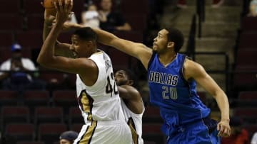 Oct 1, 2016; Bossier City, LA, USA; New Orleans Pelicans center Alexis Ajinca (42) grabs the rebound over Dallas Mavericks center A.J. Hammons (20) during the second half at CenturyLink Center. New Orleans won 116-102. Mandatory Credit: Ray Carlin-USA TODAY Sports