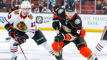ANAHEIM, CA - MARCH 4: Cam Fowler #4 of the Anaheim Ducks handles the puck with pressure from Tomas Jurco #13 of the Chicago Blackhawks during the first period of the game at Honda Center on March 4, 2018 in Anaheim, California. (Photo by Debora Robinson/NHLI via Getty Images) *** Local Caption ***
