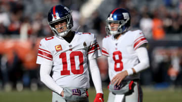 CHICAGO, ILLINOIS - NOVEMBER 24: Eli Manning #10 and Daniel Jones #8 of the New York Giants warm up before the game against the Chicago Bears at Soldier Field on November 24, 2019 in Chicago, Illinois. (Photo by Dylan Buell/Getty Images)
