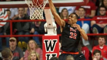 Jan 22, 2015; Bowling Green, KY, USA; UTEP Miners forward Vince Hunter (32) dunks the ball over Western Kentucky Hilltoppers forward George Fant (44) and forward Aleksej Rostov (20) and guard Chris Harrison-Docks (51) during the second half at E.A. Diddle Arena. Western Kentucky Hilltoppers defeated UTEP Miners 71-66 in overtime. Mandatory Credit: Joshua Lindsey-USA TODAY Sports
