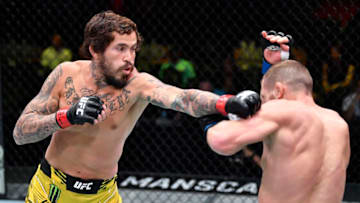 LAS VEGAS, NEVADA - JUNE 19: (L-R) Marlon Vera of Ecuador punches Davey Grant of England in a bantamweight bout during the UFC Fight Night event at UFC APEX on June 19, 2021 in Las Vegas, Nevada. (Photo by Chris Unger/Zuffa LLC)