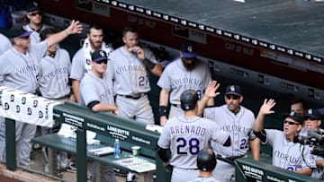 May 1, 2016; Phoenix, AZ, USA; Colorado Rockies third baseman Nolan Arenado (28) slaps hands with coaches and teammates after hitting a two-run home run in the seventh inning against the Arizona Diamondbacks at Chase Field. The Rockies won 6-3. Mandatory Credit: Joe Camporeale-USA TODAY Sports