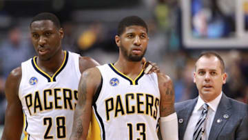 Apr 23, 2016; Indianapolis, IN, USA; Indiana Pacers center Ian Mahinmi (28) coach Frank Vogel and forward Paul George (13) walk back to the bench after a skirmish with the Toronto Raptors during the fourth quarter of game four of the first round of the 2016 NBA Playoffs at Bankers Life Fieldhouse. Indiana defeats Toronto 100-83. Mandatory Credit: Brian Spurlock-USA TODAY Sports