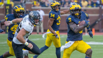 DETROIT, MI - SEPTEMBER 10: Linebacker Jabrill Peppers #5 of the Michigan Wolverines run with the football in front of linebacker Pat Jasinski #56 of the UCF Knights during a college football game at Michigan Stadium on September 10, 2016 in Ann Arbor, Michigan. The Wolverines defeated the UCF Knights 51-14. (Photo by Dave Reginek/Getty Images)
