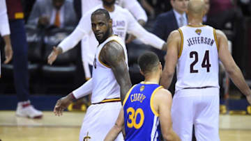 Jun 16, 2016; Cleveland, OH, USA; Cleveland Cavaliers forward LeBron James (23) stares at Golden State Warriors guard Stephen Curry (30) in the fourth quarter in game six of the NBA Finals at Quicken Loans Arena. Cleveland won 115-101. Mandatory Credit: David Richard-USA TODAY Sports