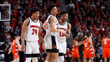 LOUISVILLE, KY - FEBRUARY 19: Jordan Nwora #33 of the Louisville Cardinals celebrates with David Johnson #13 and Dwayne Sutton #24 after hitting a three-point shot against the Syracuse Orange in the first half of a game at KFC YUM! Center on February 19, 2020 in Louisville, Kentucky. Louisville defeated Syracuse 90-66. (Photo by Joe Robbins/Getty Images)