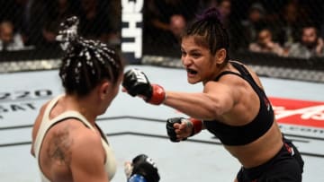 LAS VEGAS, NV - DECEMBER 30: (R-L) Cynthia Calvillo punches Carla Esparza in their women's strawweight bout during the UFC 219 event inside T-Mobile Arena on December 30, 2017 in Las Vegas, Nevada. (Photo by Jeff Bottari/Zuffa LLC/Zuffa LLC via Getty Images)