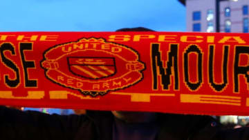 MANCHESTER, ENGLAND - DECEMBER 28: A fan poses with a Manchester United scarf displaying the image and name of former Chelsea manager Jose Mourinho, outside the stadium before the Barclays Premier League match between Manchester United and Chelsea at Old Trafford on December 28, 2015 in Manchester, England. (Photo by Alex Livesey/Getty Images)