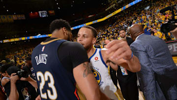 OAKLAND, CA - MAY 8: Stephen Curry #30 of the Golden State Warriors hugs Anthony Davis #23 of the New Orleans Pelicans after the game in Game Five of the Western Conference Semifinals during the 2018 NBA Playoffs on May 8, 2018 at ORACLE Arena in Oakland, California. NOTE TO USER: User expressly acknowledges and agrees that, by downloading and/or using this photograph, user is consenting to the terms and conditions of Getty Images License Agreement. Mandatory Copyright Notice: Copyright 2018 NBAE (Photo by Noah Graham/NBAE via Getty Images)