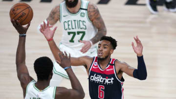 Aug 13, 2020; Lake Buena Vista, Florida, USA; Boston Celtics' Semi Ojeleye, left, passes around Washington Wizards' Troy Brown Jr. (6) during the second half of an NBA basketball game Thursday, Aug. 13, 2020 in Lake Buena Vista, Fla. at ESPN Wide World of Sports Complex. Mandatory Credit: Ashley Landis/Pool Photo-USA TODAY Sports