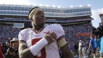 Nov 30, 2013; Gainesville, FL, USA; Florida State Seminoles quarterback Jameis Winston (5) after they beat the Florida Gators at Ben Hill Griffin Stadium. Florida State Seminoles defeated the Florida Gators 37-7. Mandatory Credit: Kim Klement-USA TODAY Sports