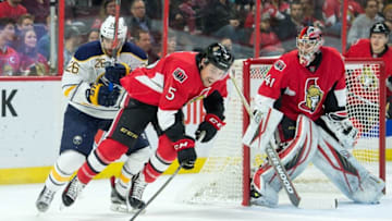 Feb 16, 2016; Ottawa, Ontario, CAN; Ottawa Senators defenseman Cody Ceci (5) skates with the puck in front of Buffalo Sabres left wing Matt Moulson (26) in the first period at the Canadian Tire Centre. Mandatory Credit: Marc DesRosiers-USA TODAY Sports