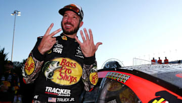 KANSAS CITY, KS - OCTOBER 22: Martin Truex Jr., driver of the #78 Bass Pro Shops/Tracker Boats Toyota, celebrates with the winner's decal in Victory Lane after winning the Monster Energy NASCAR Cup Series Hollywood Casino 400 at Kansas Speedway on October 22, 2017 in Kansas City, Kansas. (Photo by Sarah Crabill/Getty Images)