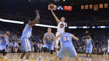 April 10, 2014; Oakland, CA, USA; Golden State Warriors guard Stephen Curry (30) shoots the ball against Denver Nuggets forward Kenneth Faried (35), center Timofey Mozgov (25), and guard Evan Fournier (94) during the fourth quarter at Oracle Arena. The Nuggets defeated the Warriors 100-99. Mandatory Credit: Kyle Terada-USA TODAY Sports