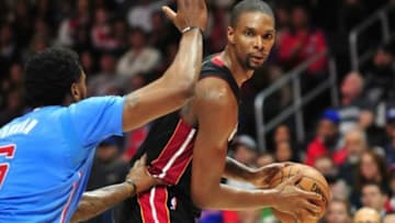 January 11, 2015; Los Angeles, CA, USA; Miami Heat center Chris Bosh (1) controls the ball against the defense of Los Angeles Clippers center DeAndre Jordan (6) during the first half at Staples Center. Mandatory Credit: Gary A. Vasquez-USA TODAY Sports