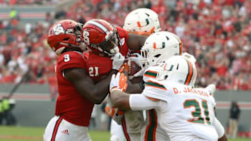 Nov 19, 2016; Raleigh, NC, USA; North Carolina State Wolfpack running back Matt Dayes (21) fights for yards during the second half against the Miami Hurricanes at Carter Finley Stadium. Miami won 27-13. Mandatory Credit: Rob Kinnan-USA TODAY Sports