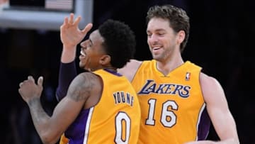 Dec 20, 2013; Los Angeles, CA, USA; Los Angeles Lakers small forward Nick Young (0) celebrates a 3-point basket by center Pau Gasol (16) in the second half of the game against the Minnesota Timberwolves at Staples Center. The Lakers won 104-91. Mandatory Credit: Jayne Kamin-Oncea-USA TODAY Sports