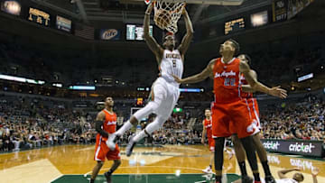 Dec 13, 2014; Milwaukee, WI, USA; Milwaukee Bucks center Larry Sanders (8) dunks as Los Angeles Clippers forward Matt Barnes (22) looks on during the first quarter at BMO Harris Bradley Center. Mandatory Credit: Jeff Hanisch-USA TODAY Sports