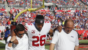TAMPA, FLORIDA - SEPTEMBER 22: Running back Saquon Barkley #26 of the New York Giants is helped back to the locker room by medical staff after an injury during the game against the Tampa Bay Buccaneers at Raymond James Stadium on September 22, 2019 in Tampa, Florida. (Photo by Mike Zarrilli/Getty Images)