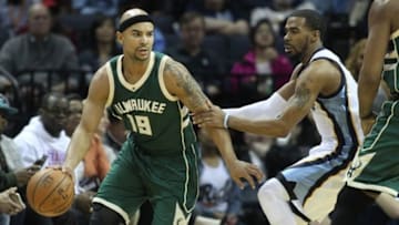 Jan 28, 2016; Memphis, TN, USA; Milwaukee Bucks guard Jerryd Bayless (19) dribbles the ball as Memphis Grizzlies guard Mike Conley (11) defends in the second quarter at FedExForum. Mandatory Credit: Nelson Chenault-USA TODAY Sports