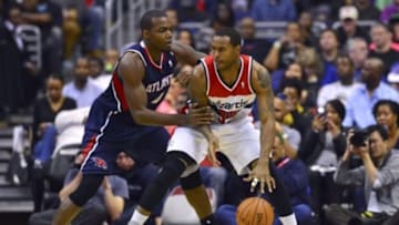 Mar 29, 2014; Washington, DC, USA; Washington Wizards forward Trevor Booker (35) dribbles as Atlanta Hawks forward Paul Millsap (4) during the third quarter at Verizon Center. Washington Wizards defeated Atlanta Hawks 101-97. Mandatory Credit: Tommy Gilligan-USA TODAY Sports