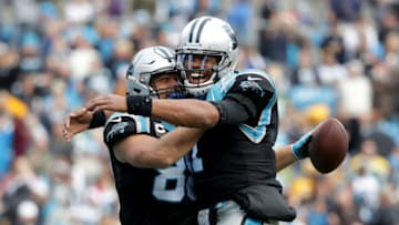 CHARLOTTE, NC - DECEMBER 17: Greg Olsen #88 celebrates with teammate Cam Newton #1 of the Carolina Panthers after a touchdown against the Green Bay Packers in the third quarter during their game at Bank of America Stadium on December 17, 2017 in Charlotte, North Carolina. (Photo by Streeter Lecka/Getty Images)