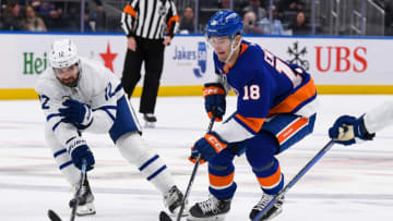 Mar 21, 2023; Elmont, New York, USA; New York Islanders left wing Pierre Engvall (18) skates across the blue line defended by Toronto Maple Leafs center Zach Aston-Reese (12) during the second period at UBS Arena. Mandatory Credit: Dennis Schneidler-USA TODAY Sports
