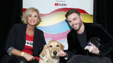 BEVERLY HILLS, CA - OCTOBER 22: (L-R) Paula Godwin and Todd the Hero Dog, winners of the Milk-Bone Dog of the Year Honor, and Gus Kenworthy pose backstage during The 8th Annual Streamy Awards at The Beverly Hilton Hotel on October 22, 2018 in Beverly Hills, California. (Photo by Rich Polk/Getty Images for Streamy Awards)