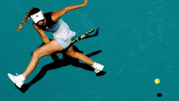 MIAMI GARDENS, FLORIDA - MARCH 23: Caroline Wozniacki of Denmark hits a ball between her legs while playing Monica Niculescu of Romania during the Miami Open Presented by Itau at Hard Rock Stadium March 23, 2019 in Miami Gardens, Florida.(Photo by Matthew Stockman/Getty Images)