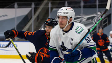 EDMONTON, AB - MAY 15: Bo Horvat #53 of the Vancouver Canucks battles against Darnell Nurse #25 of the Edmonton Oilers at Rogers Place on May 15, 2021 in Edmonton, Canada. (Photo by Codie McLachlan/Getty Images)