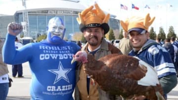 Nov 28, 2013; Arlington, TX, USA; Dallas Cowboys fans pose with a turkey during tailgate festivities before a NFL football game on Thanksgiving against the Oakland Raiders at AT&T Stadium. Mandatory Credit: Kirby Lee-USA TODAY Sports