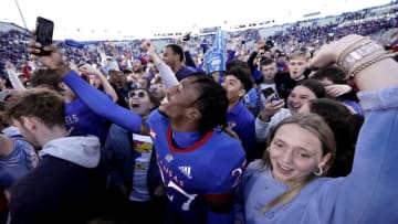 LAWRENCE, KS - NOVEMBER 05: Safety Kenrick Osei-Bonsu #27 of the Kansas Jayhawks celebrates with fans after their 37-16 win over Oklahoma State Cowboys at David Booth Kansas Memorial Stadium on November 5, 2022 in Lawrence, Kansas. (Photo by Ed Zurga/Getty Images)