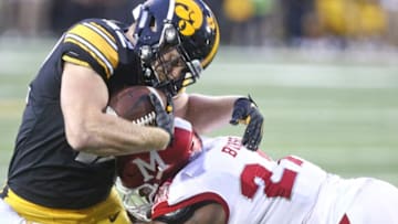 IOWA CITY, IOWA- AUGUST 31: Tight end Shaun Beyer #42 of the Iowa Hawkeyes is tackled during the first half by linebacker Kobe Burse #27 of the Miami Ohio RedHawks on August 31, 2019 at Kinnick Stadium in Iowa City, Iowa. (Photo by Matthew Holst/Getty Images)