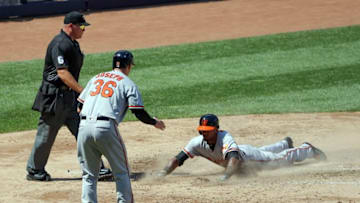 Jul 21, 2016; Bronx, NY, USA; Baltimore Orioles catcher Caleb Joseph (36) and center fielder Julio Borbon (29) score during the seventh inning against the New York Yankees at Yankee Stadium. Mandatory Credit: Anthony Gruppuso-USA TODAY Sports