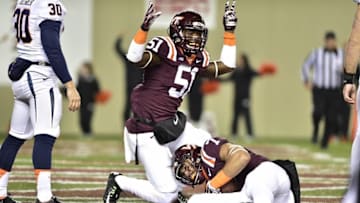 Nov 28, 2014; Blacksburg, VA, USA; Virginia Tech Hokies tight end Bucky Hodges (7) recovers a blocked punt of Virginia Cavaliers punter Alec Vozenilek (30) as Virginia Tech Hokies linebacker Melvin Keihn (51) reacts in the second quarter at Lane Stadium. Mandatory Credit: Bob Donnan-USA TODAY Sports