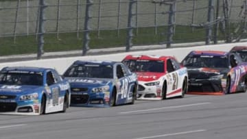 May 3, 2015; Talladega, AL, USA; Sprint Cup Series driver Dale Earnhardt Jr. (88), driver Ryan Blaney (21), driver Ryan Blaney (21), and driver Denny Hamlin (11) race during the GEICO 500 at Talladega Superspeedway. Mandatory Credit: Marvin Gentry-USA TODAY Sports