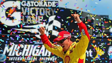 Aug 18, 2013; Brooklyn, MI, USA; NASCAR Sprint Cup Series driver Joey Logano celebrates in victory lane after winning the Pure Michigan 400 at Michigan International Speedway. Mandatory Credit: Andrew Weber-USA TODAY Sports