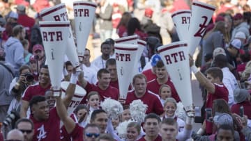 Nov 26, 2016; Tuscaloosa, AL, USA; Alabama Crimson Tide cheerleaders walk behind the team coming into the stadium prior to the game against the Auburn Tigers at Bryant-Denny Stadium. Mandatory Credit: Marvin Gentry-USA TODAY Sports