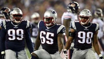 Aug 18, 2016; Foxborough, MA, USA; New England Patriots offensive guard Jonathan Cooper (65) reacts with defensive end Trey Flowers (98) and defensive tackle Vincent Valentine (99) after making a tackle during the first half against the Chicago Bears at Gillette Stadium. Mandatory Credit: Bob DeChiara-USA TODAY Sports