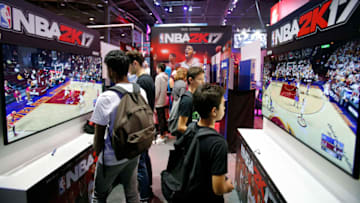 PARIS, FRANCE - OCTOBER 28: Gamers play the video game 'NBA 2K 17' developed by Visual Concepts and published 2K Sports on Sony PlayStation game consoles PS4 during the 'Paris Games Week' on October 28, 2016 in Paris, France. 'Paris Games Week' is an international trade fair for video games to be held from October 27 to October 31, 2016. (Photo by Chesnot/Getty Images)
