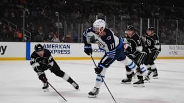 Oct 28, 2021; Los Angeles, California, USA; Winnipeg Jets left wing Adam Lowry (17) shoots the puck as LA Kings defenseman Mikey Anderson (44) defends in the first period at Staples Center. Mandatory Credit: Kirby Lee-USA TODAY Sports
