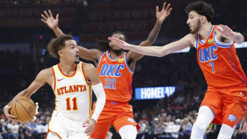 Nov 6, 2023; Oklahoma City, Oklahoma, USA; Atlanta Hawks guard Trae Young (11) is defended by Oklahoma City Thunder guard Cason Wallace (22) and forward Chet Holmgren (7) during the second quarter at Paycom Center. Mandatory Credit: Alonzo Adams-USA TODAY Sports