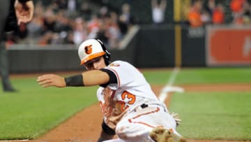 Apr 21, 2016; Baltimore, MD, USA; Baltimore Orioles outfielder Joey Rickard (23) scores the go-ahead run in the eighth inning against the Toronto Blue Jays at Oriole Park at Camden Yards. Mandatory Credit: Evan Habeeb-USA TODAY Sports