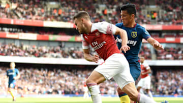 LONDON, ENGLAND - AUGUST 25: Aaron Ramsey of Arsenal is challenged by Lucas Perez of West Ham United during the Premier League match between Arsenal FC and West Ham United at Emirates Stadium on August 25, 2018 in London, United Kingdom. (Photo by Clive Mason/Getty Images)