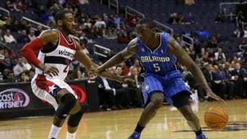Feb 25, 2014; Washington, DC, USA; Orlando Magic shooting guard Victor Oladipo (5) dribbles the ball as Washington Wizards point guard John Wall (2) defends in the fourth quarter at Verizon Center. The Wizards won 115-106. Mandatory Credit: Geoff Burke-USA TODAY Sports