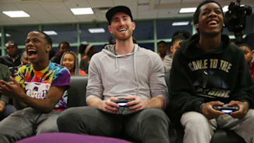 BOSTON, MA - DECEMBER 13: Boston Celtics player Gordon Hayward is flanked by Tate Ross, left and Tavadre Bailey, right, while playing a video game during a visit to the Boys & Girls Clubs of Boston on Dec. 13, 2017. (Photo by Craig F. Walker/The Boston Globe via Getty Images)